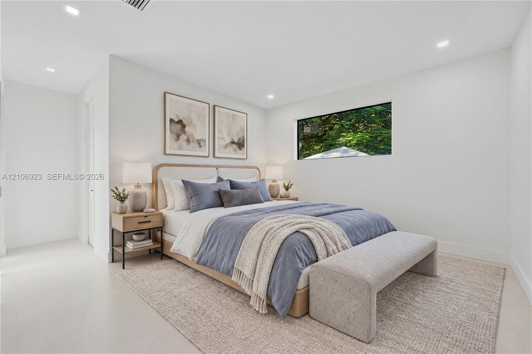 Neutral-toned interior featuring recessed ceiling lighting, light-colored tile flooring, and a horizontal rectangular window