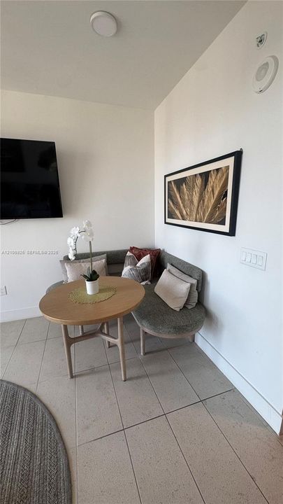 Neutral-toned tile flooring, white wall finishes, and integrated wall-mounted lighting