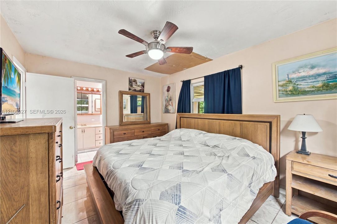 Ceramic tile flooring, central ceiling fan with integrated lighting, and neutral-toned wall paint