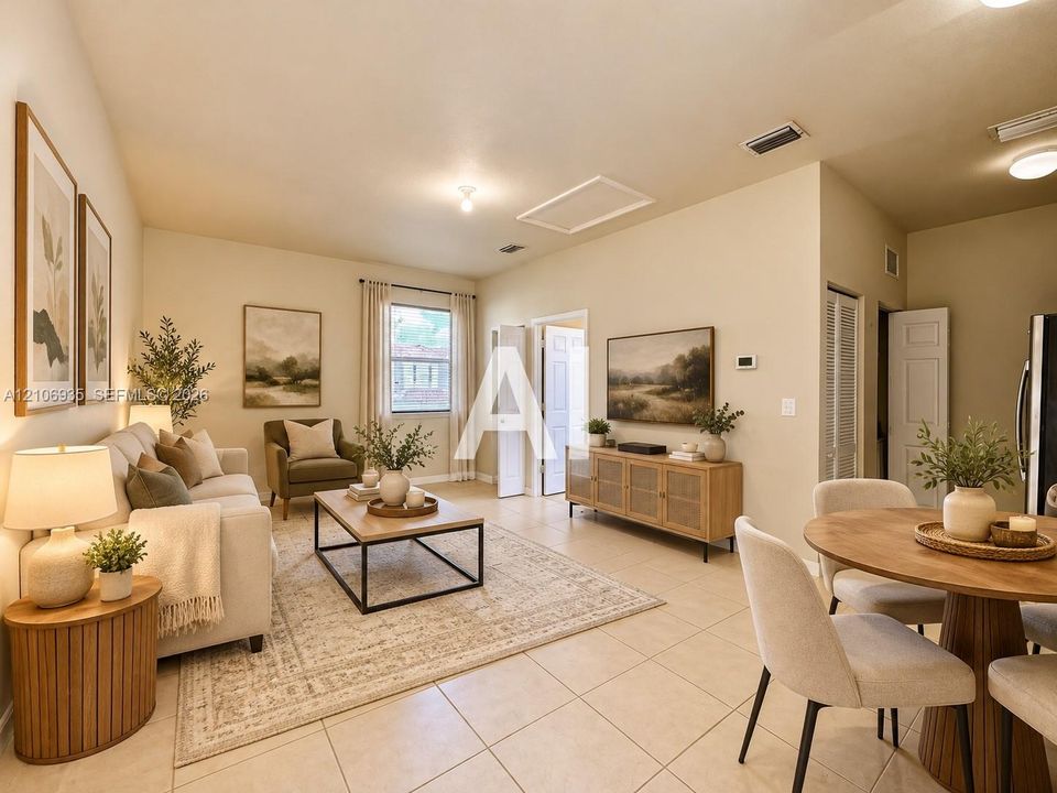 Open-concept interior featuring light-toned tile flooring, recessed lighting, and a single window with neutral drapery