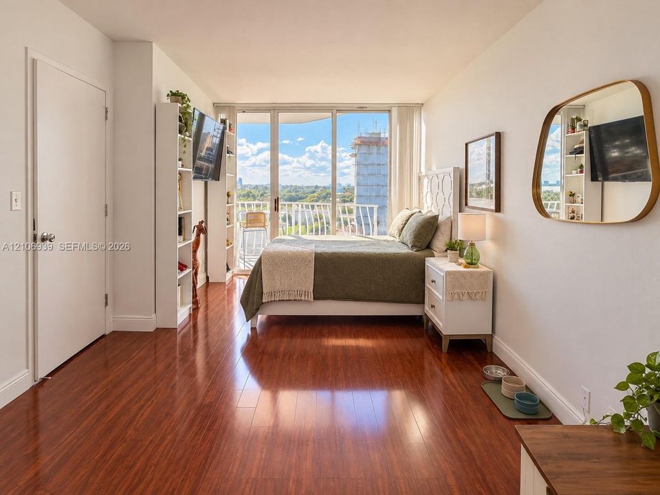 Wood-finish flooring, floor-to-ceiling windows, and access to a private balcony