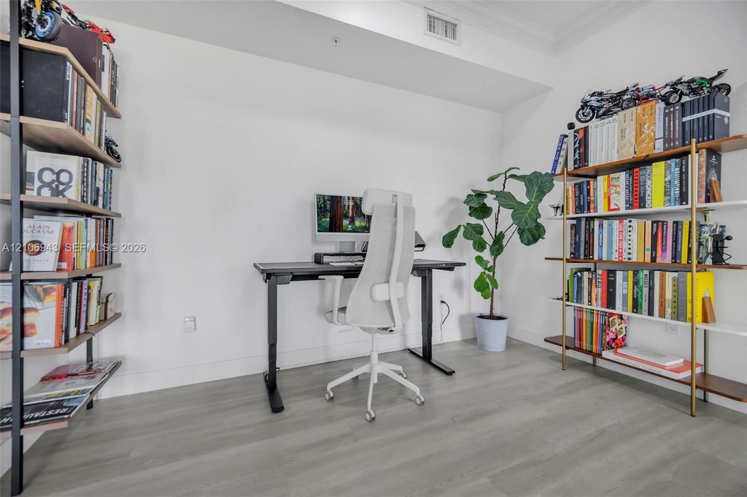 Interior space featuring wood-finish flooring and crown molding