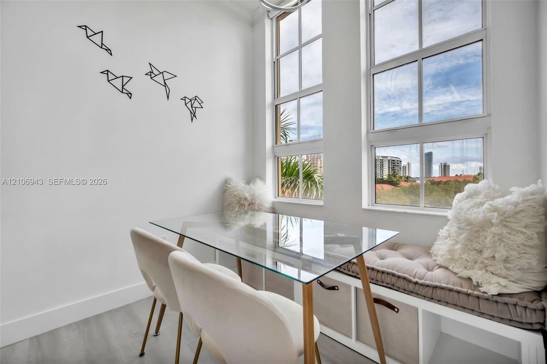 Double-hung windows featuring grid detailing, built-in cabinetry, and wood-finish flooring