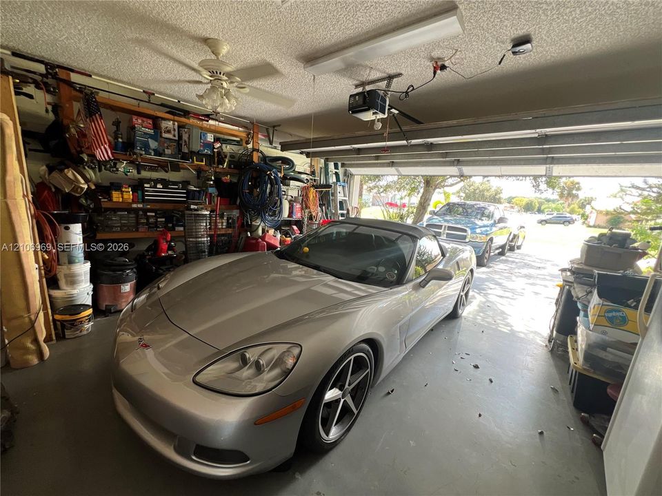 Attached garage featuring an automated overhead door system and an integrated ceiling-mounted light fixture