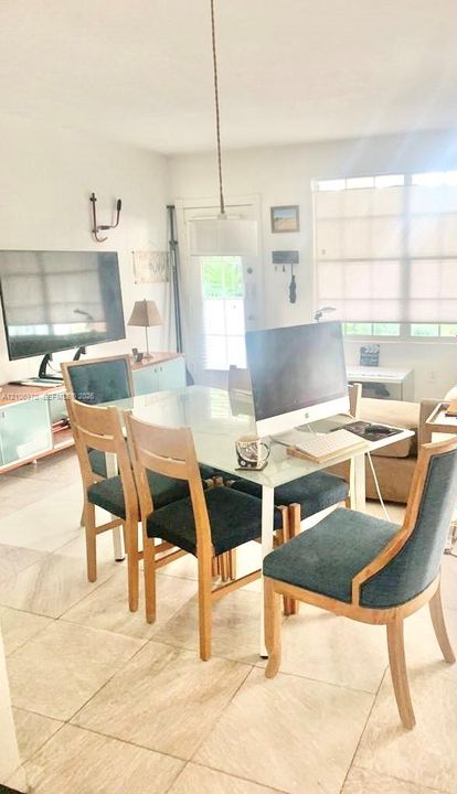 Large-format tile flooring, pendant lighting fixture, and window with built-in shades