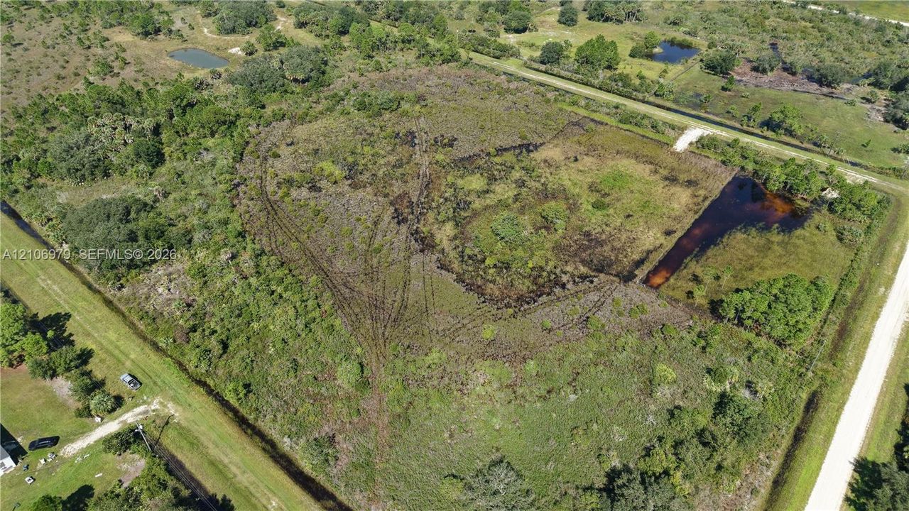 Expansive acreage featuring natural vegetation, native trees, and multiple water features