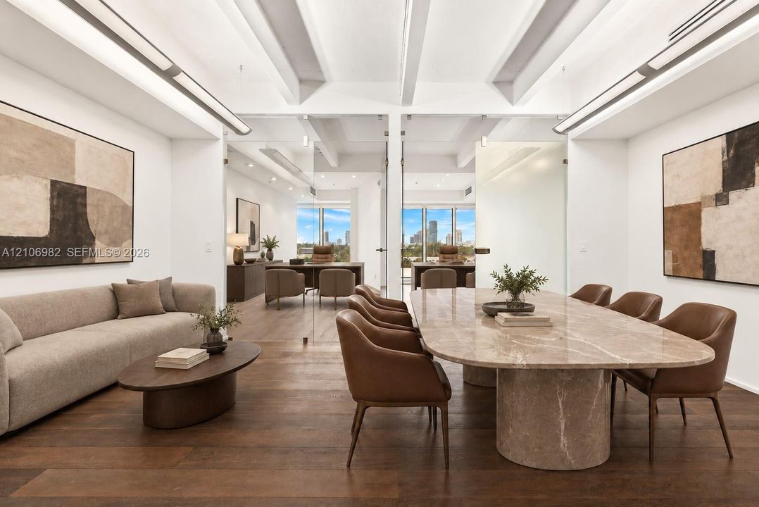 Exposed beam ceiling, wood-finish flooring, floor-to-ceiling glass partitions, and linear recessed lighting
