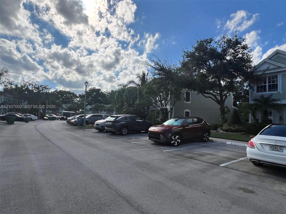 Dedicated parking area featuring marked spaces and asphalt surfacing