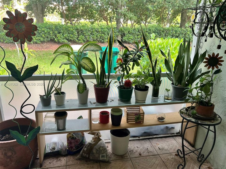 Enclosed porch featuring tiled flooring and a translucent, framed screen enclosure