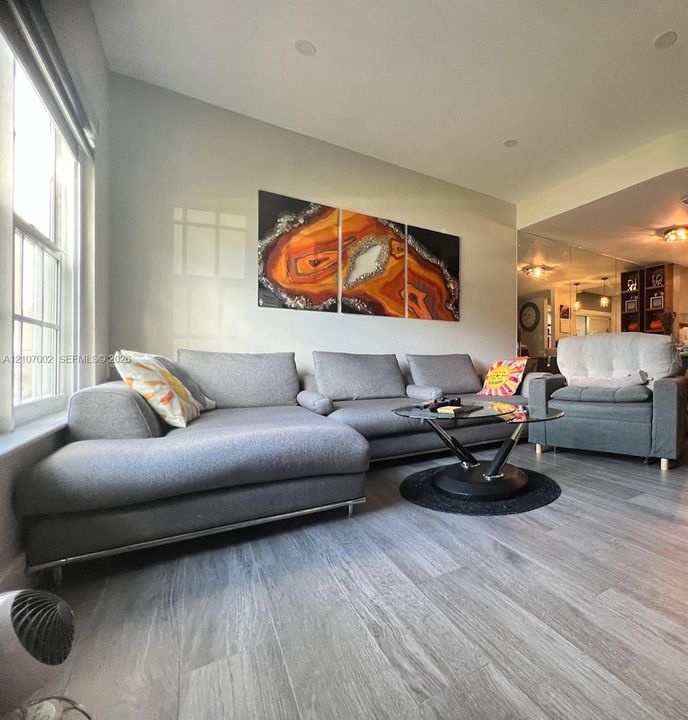 Wood-finish flooring, recessed lighting, and multi-pane windows