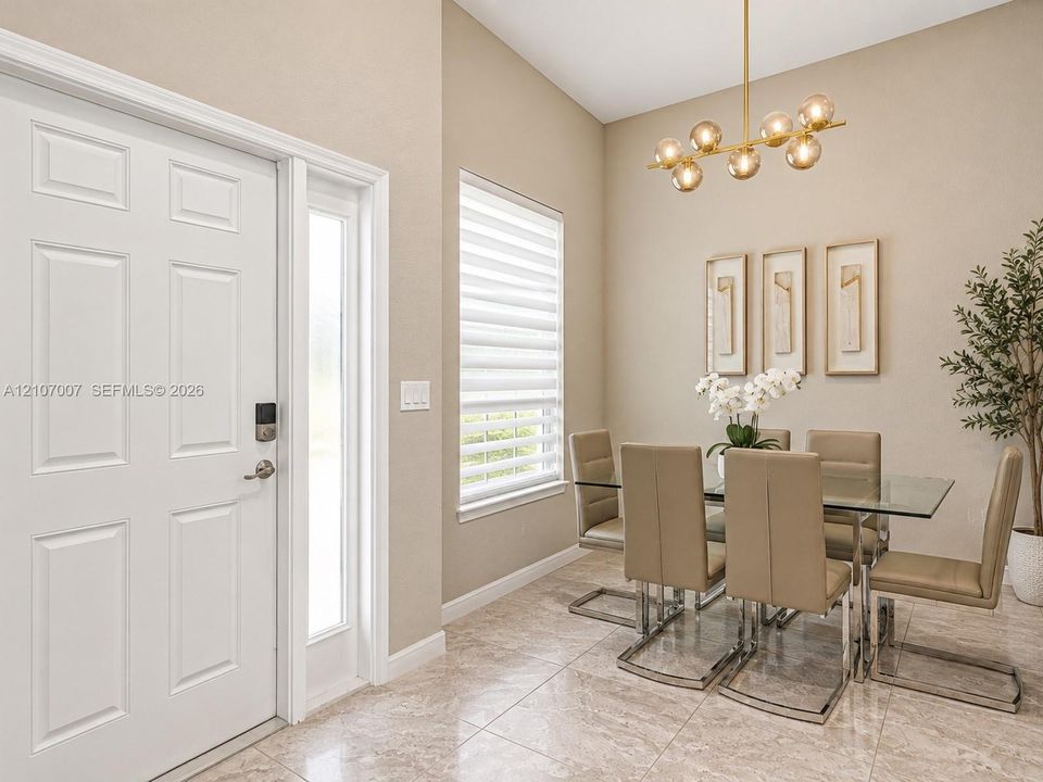 High-ceiling interior featuring a six-panel entry door with side-light, tile flooring, tiered window shades, and a multi-globe pendant light fixture