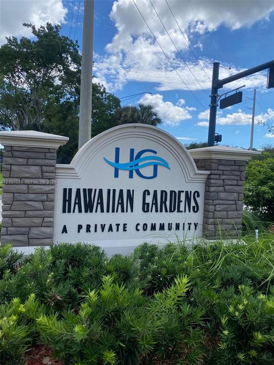 Entrance monument featuring stone-finish masonry piers and custom community signage
