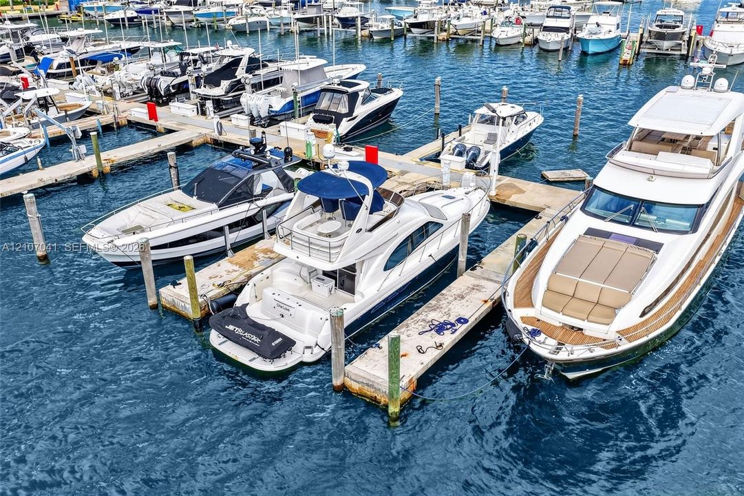 Deep-water marina featuring individual concrete slip piers, secure piling supports, and organized vessel docking infrastructure