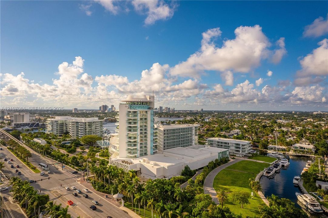 High-rise coastal development featuring tiered structural design, private balconies, expansive waterfront exposure, and integrated marina access