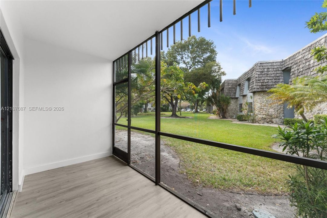 Enclosed porch featuring screen paneling, wood-finish flooring, and expansive glass exposure