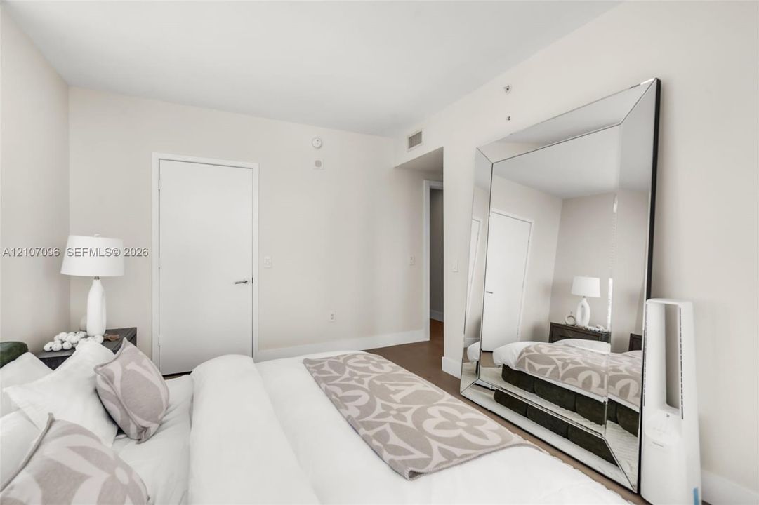 Neutral-toned interior space featuring wood-finish flooring and solid-core interior doors