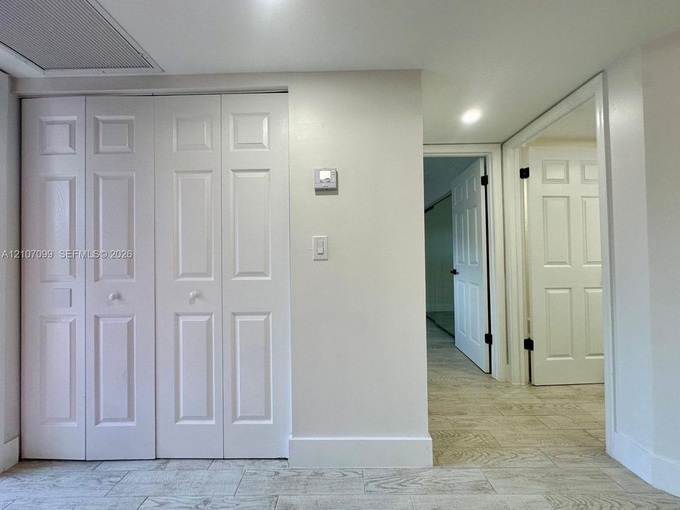 Bi-fold closet doors, six-panel interior doors, and tile flooring