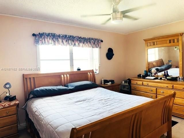 Primary Bedroom featuring a dual-pane window and a ceiling-mounted light fixture with room for queen sized bed