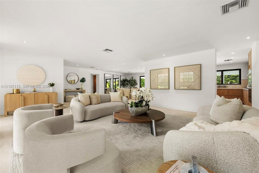 Open floor plan featuring recessed lighting, smooth white walls, light-toned flooring, and neutral finishes