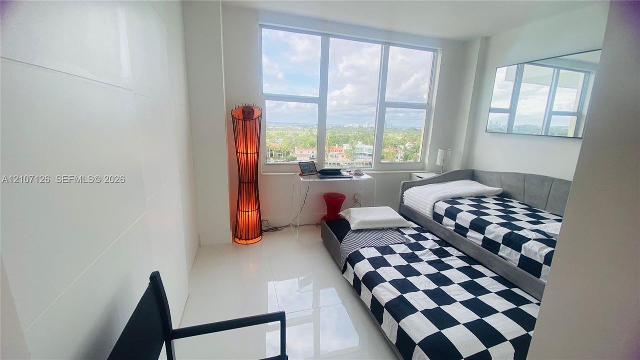 Floor-to-ceiling windows, high-gloss tile flooring, and wall-mounted mirror