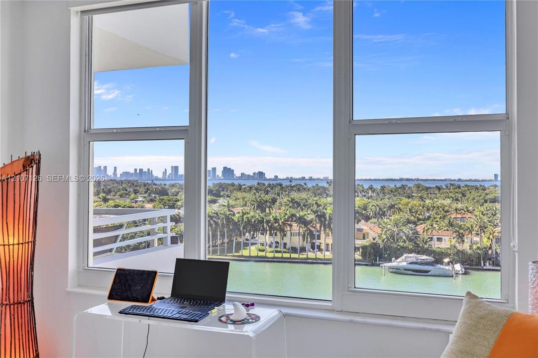 Large multi-pane windows providing natural light and expansive outdoor water and cityscape scenery