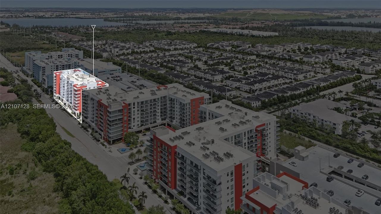Multi-story residential complex featuring private balconies, architectural masonry, and perimeter landscaping