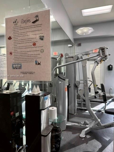 Fitness center featuring wall-to-wall mirrors, recessed lighting, and a multi-station weight training system