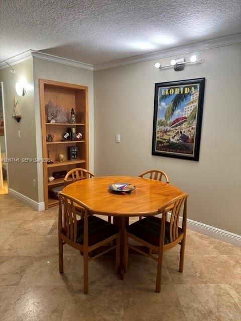 Built-in wood shelving, stone-finish flooring, crown molding, and tri-light fixture