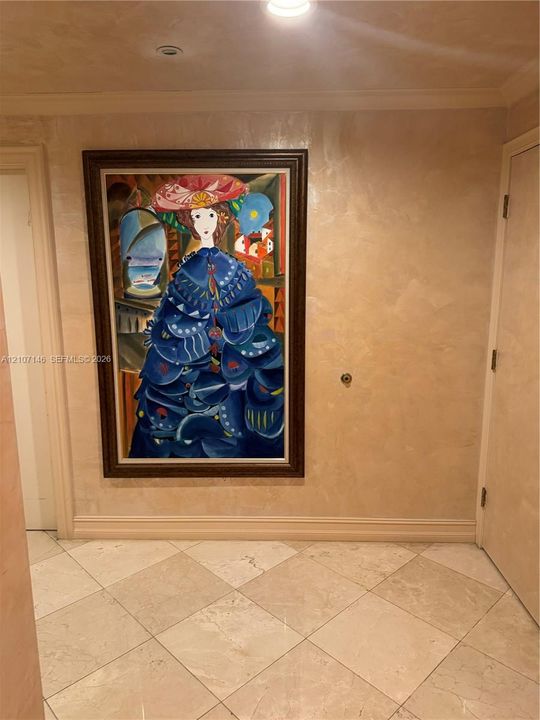 Textured wall finish featuring a metallic luster, stone tile flooring, and recessed ceiling lighting