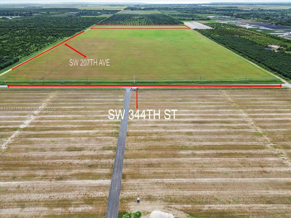 Expansive acreage featuring dual road frontage on SW 207th Ave and SW 344th St, flat terrain, and paved road access