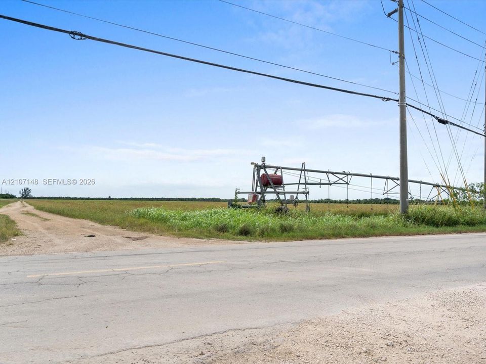 Open acreage featuring level terrain, native grasses, and an installed center-pivot irrigation system