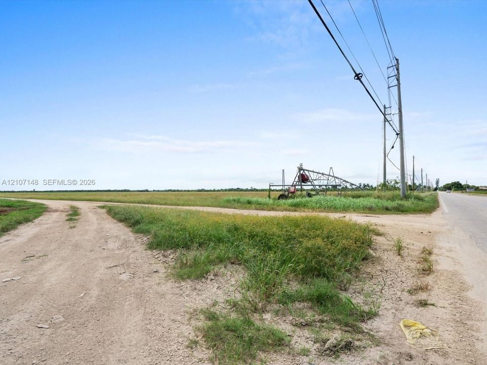 Expansive acreage featuring cleared land, native grasses, and an irrigation system