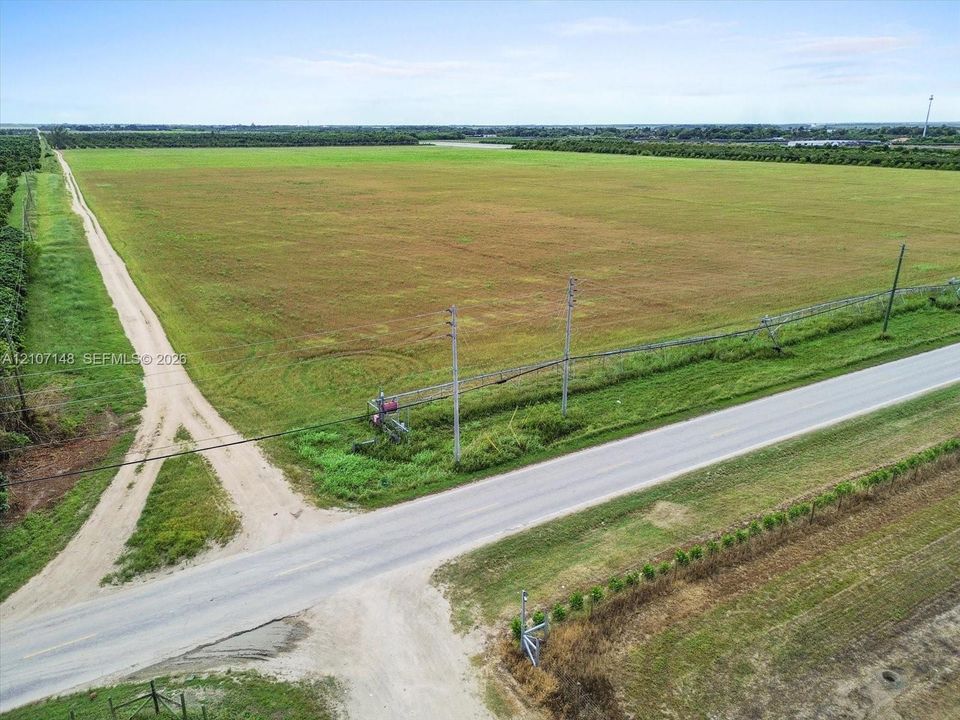 Expansive level acreage featuring paved road frontage, utility access, and an integrated irrigation system