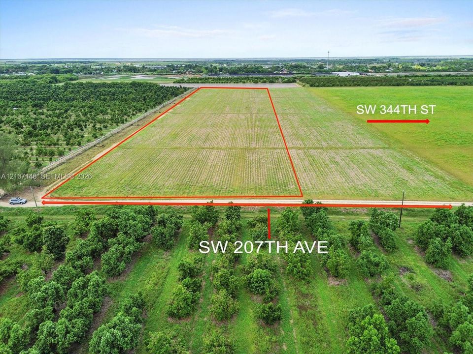 Expansive agricultural parcel featuring level terrain, direct frontage on two roadways, and open acreage