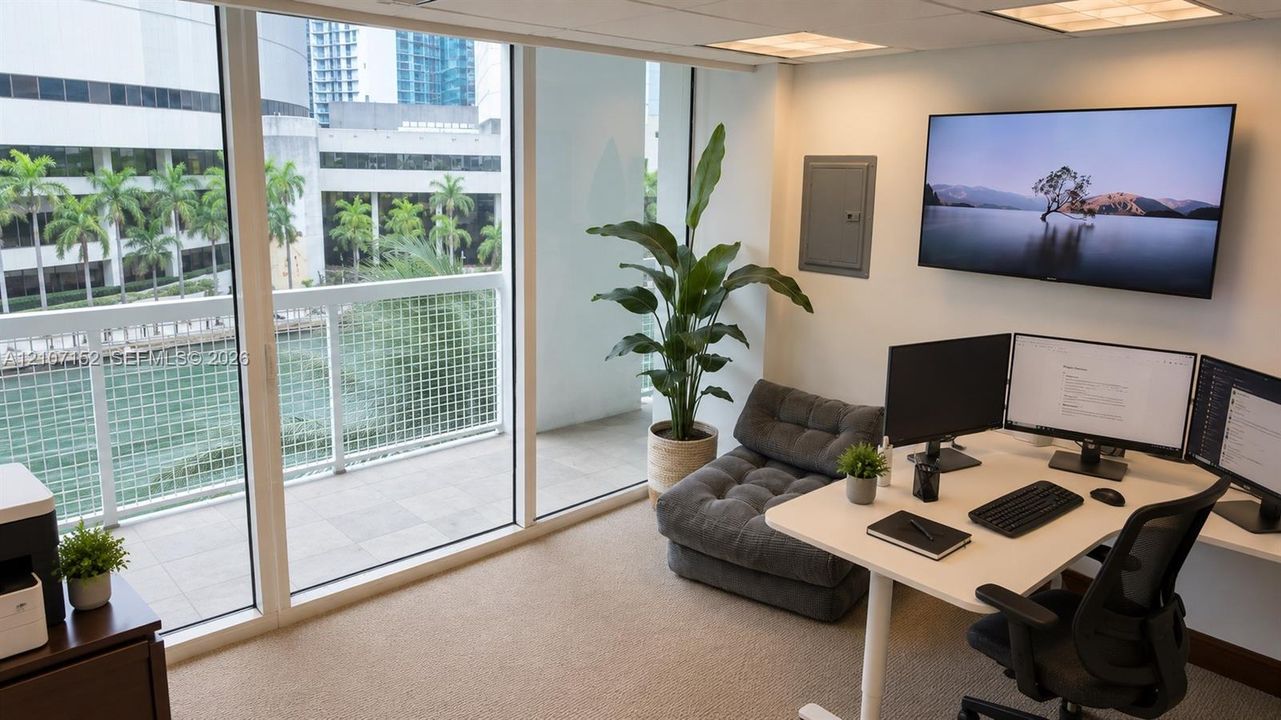 Floor-to-ceiling windows, private balcony with metal railing, neutral carpeting, recessed ceiling lighting, and wall-mounted electrical panel