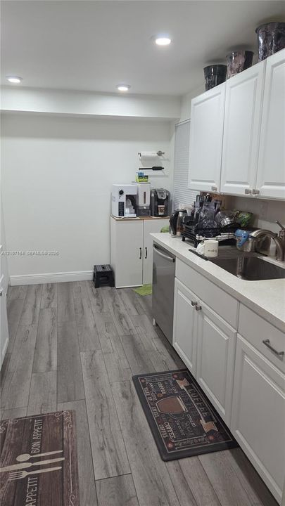 Kitchen featuring white shaker-style cabinetry, wood-finish flooring, recessed lighting, and a stainless steel undermount sink