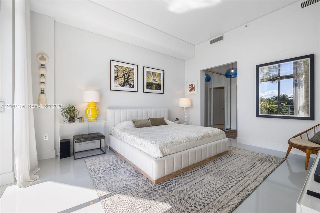 Expansive room featuring high ceilings, smooth flooring, and a large window