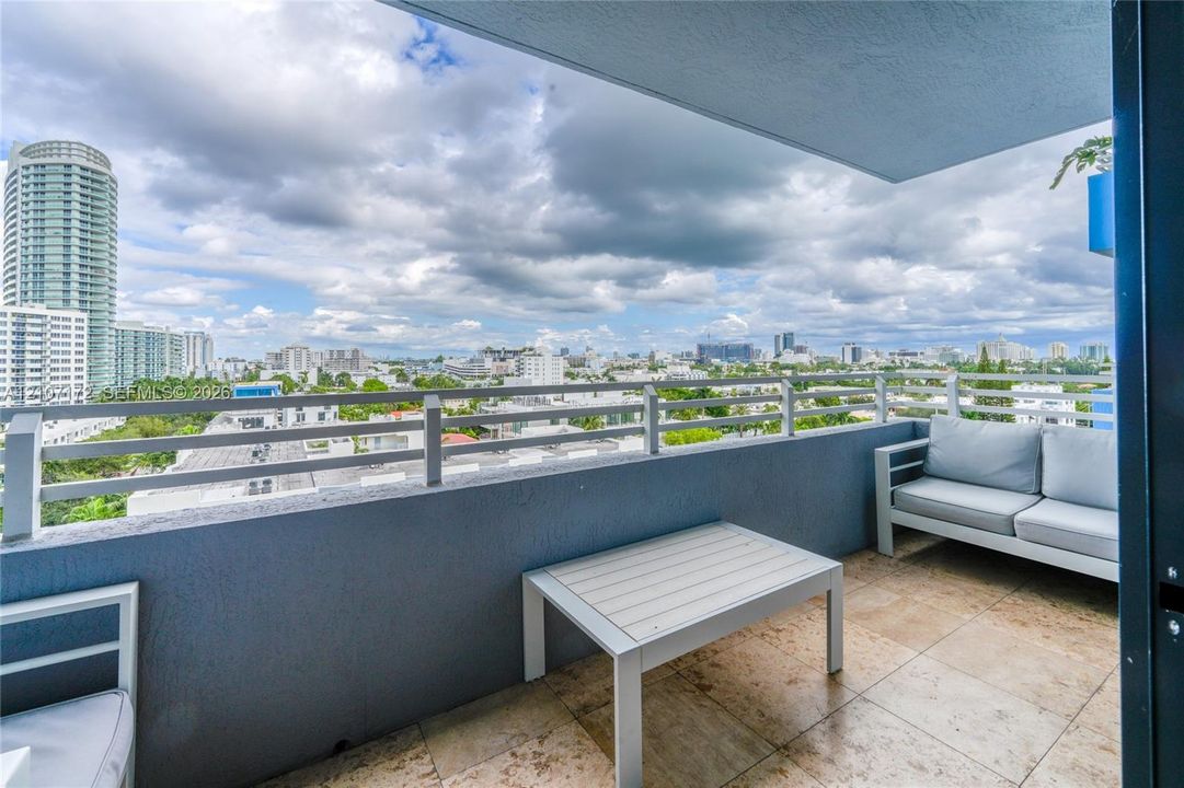 Covered balcony featuring tile flooring and horizontal metal railing