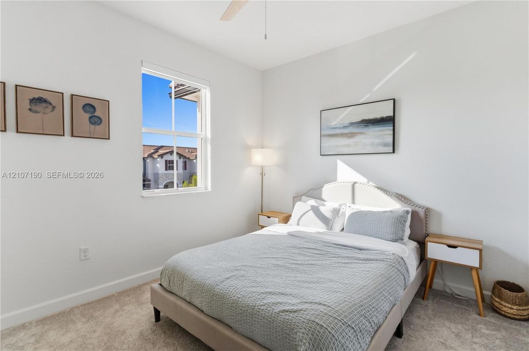 Neutral wall tones, carpeting, double-hung window, and ceiling fan