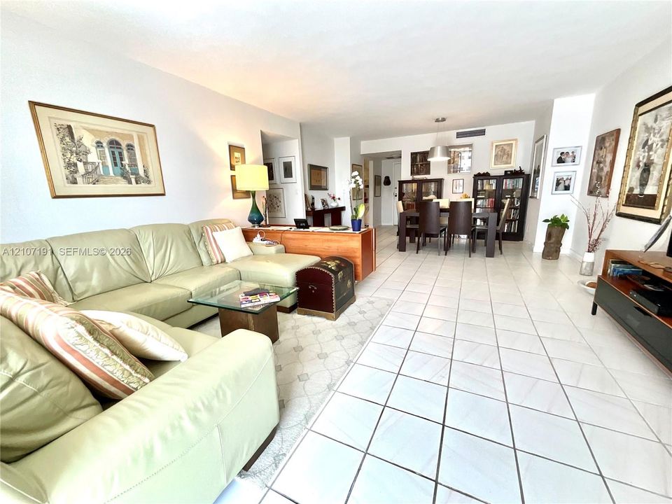Open-concept interior featuring white tiled flooring throughout and recessed ceiling lighting