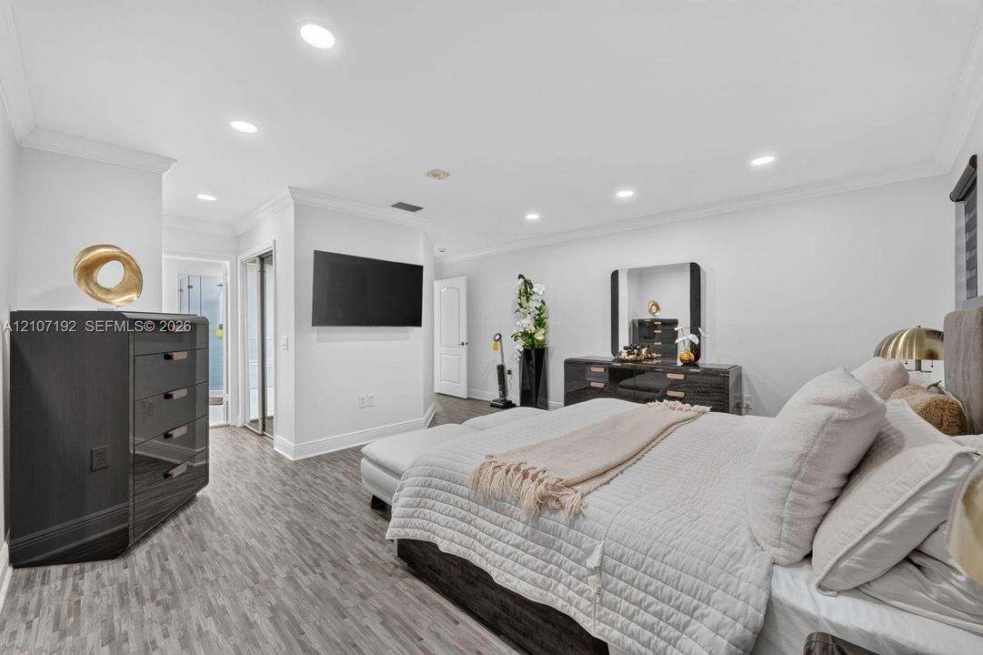 Interior space featuring wood-finish flooring, recessed lighting, crown molding, and two-panel interior doors