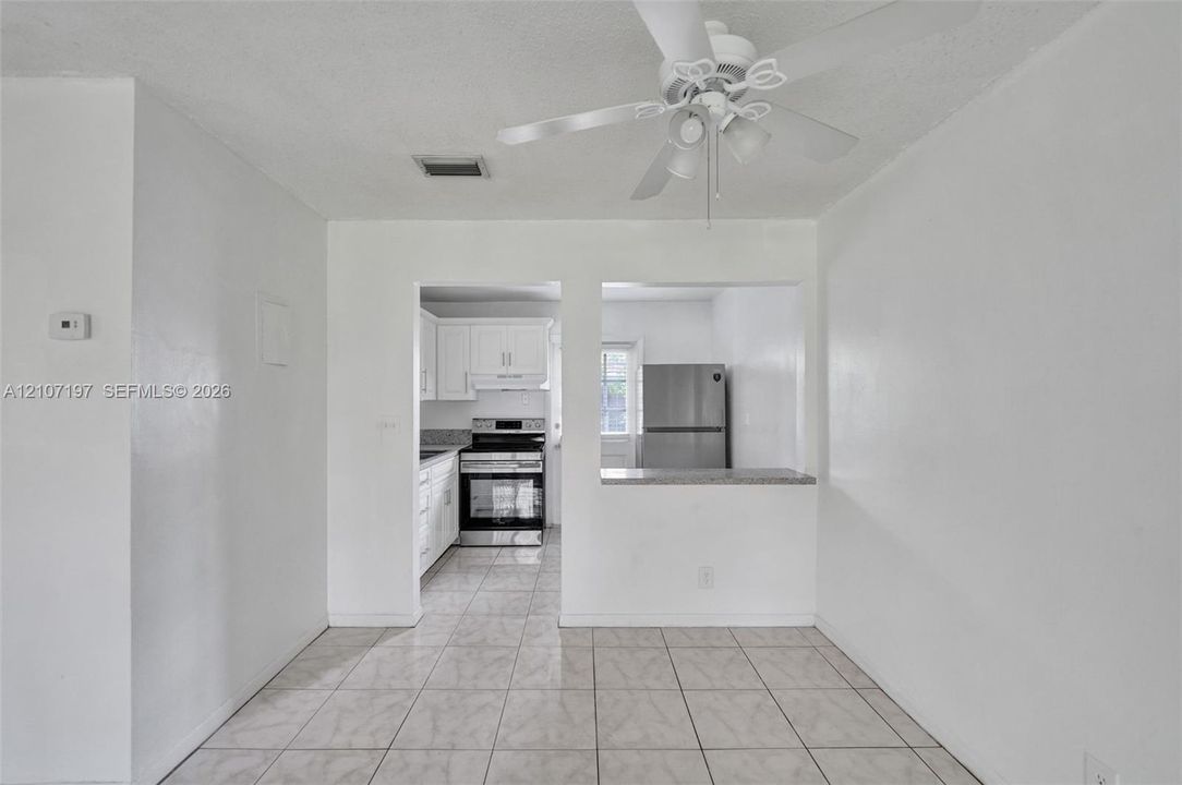 Interior space featuring tile flooring and a ceiling-mounted light fixture with a fan