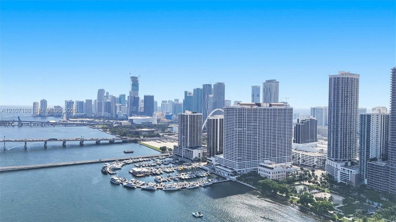 Panoramic urban skyline featuring expansive waterfront exposure, a deep-water marina, and extensive bridge infrastructure