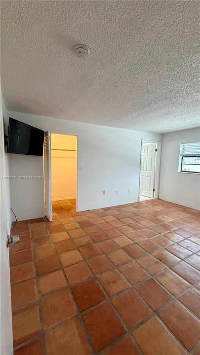 Ceramic tile flooring, multi-panel interior door, and built-in closet shelving