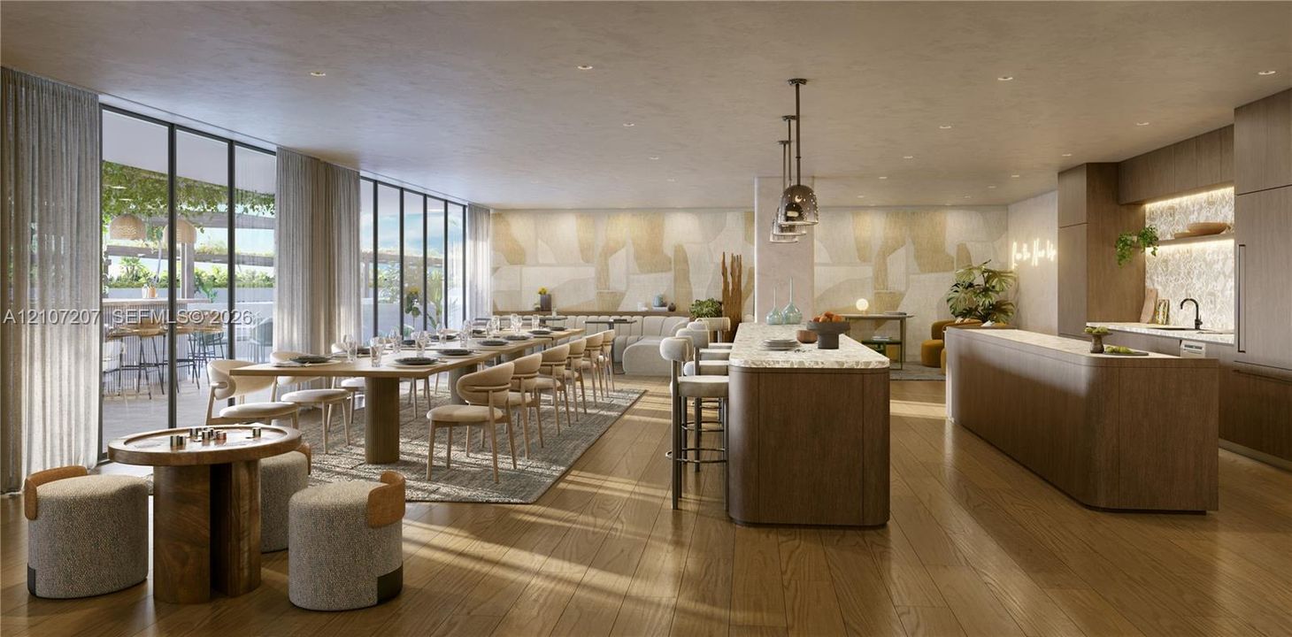 Open-concept space featuring floor-to-ceiling windows, wood-finish flooring, two expansive kitchen islands with stone countertops, and recessed lighting