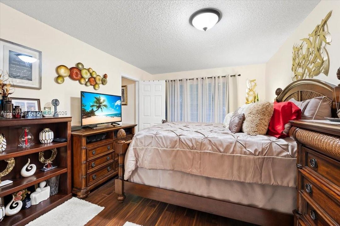 Wood-finish flooring, multi-pane window with integrated blinds, and a six-panel interior door