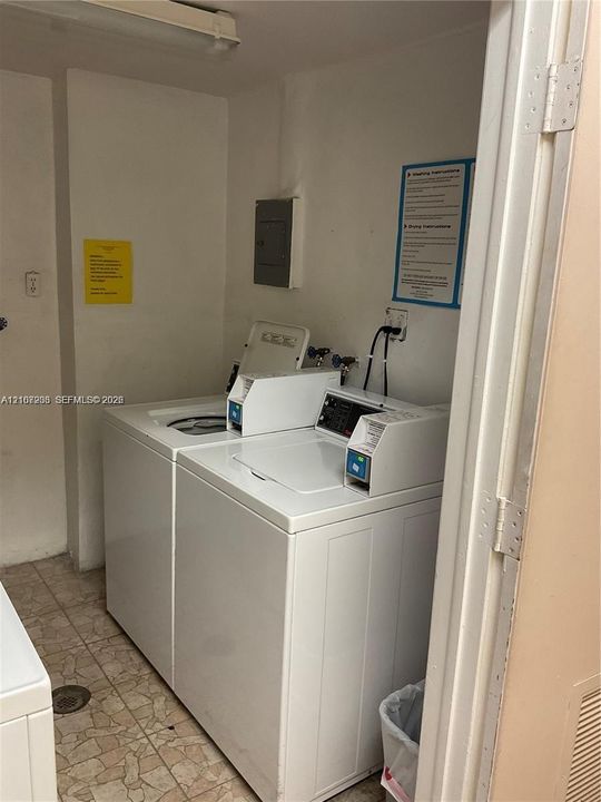 Utility area featuring white top-loading laundry appliances and ceramic tile flooring
