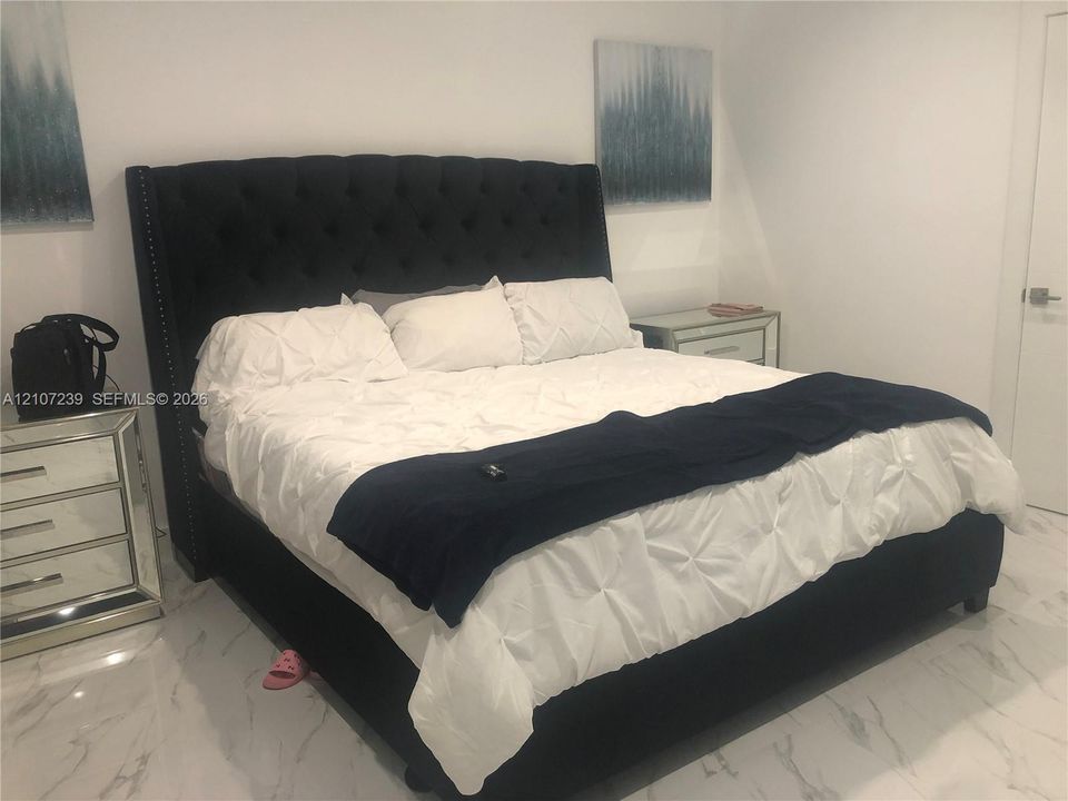 Neutral wall color and white stone-finish flooring