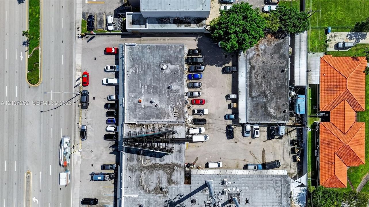 Commercial property featuring multi-building site, paved surface parking lot, and direct street access
