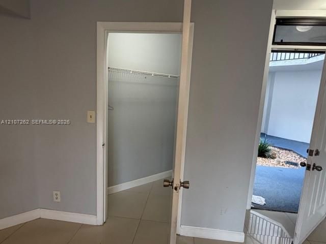 Interior space featuring neutral wall paint, tile flooring, and a built-in wire closet shelving system
